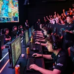 Competitive players at a Sunwin eSports gaming tournament displaying intense focus and excitement.