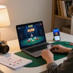 Engaged player using AU88 app on laptop, surrounded by betting notes and coffee.