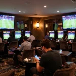 Watch bettors engage with live sports events in the vibrant ga8888 betting lounge.