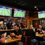 Engaging sports betting scene at Kkeonhacai platform with excited patrons placing bets.
